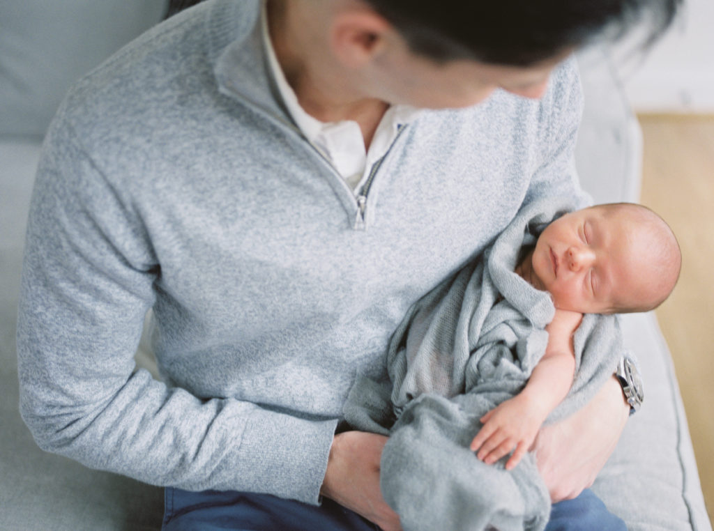 A Dad Holding His Baby In The Hospital.