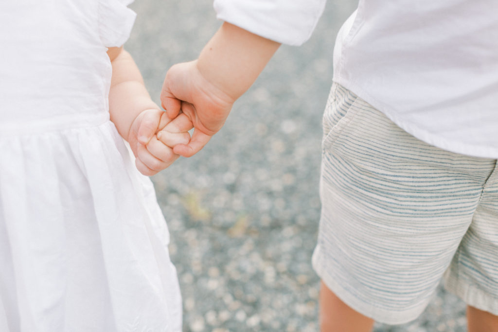 Two Kids Holding Hands During Maryland Family Photo Session.