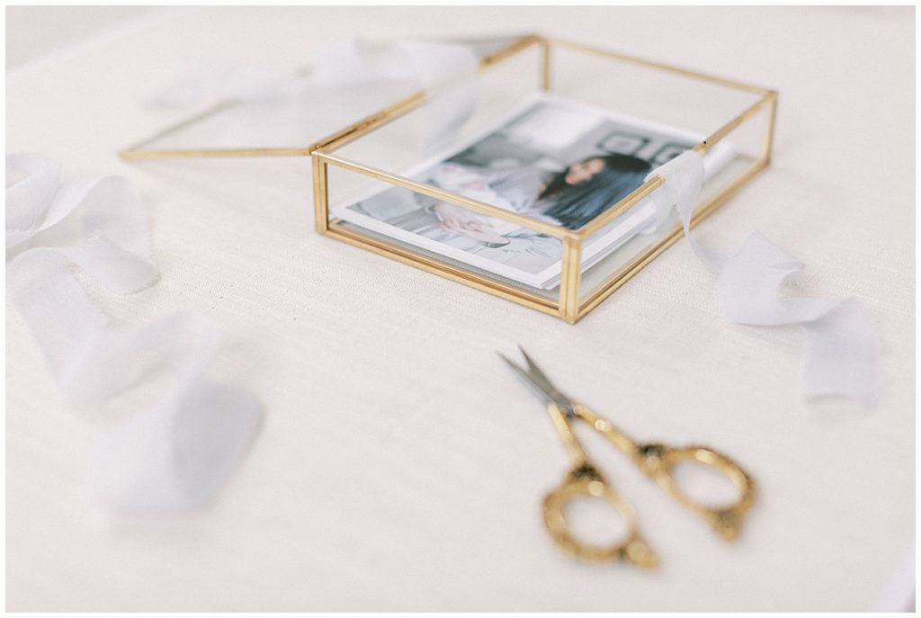 Print Proofs In A Glass Box And Gold Scissors And Blue Ribbon For Dc Fine Art Photographer Marie Elizabeth Photography