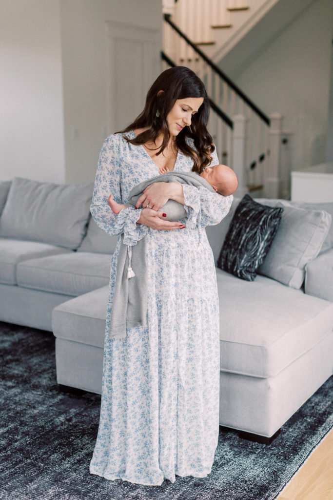 Bethesda Newborn Photographer - A Mother Looks Adoringly At Her Baby.