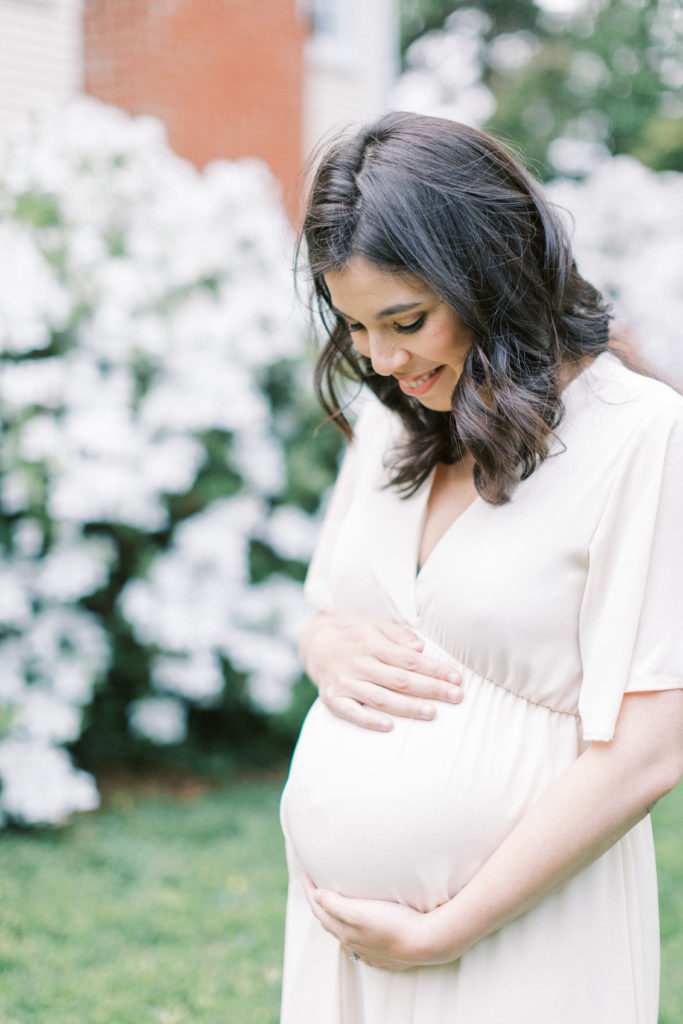 A Mother Smiling Down At Her Belly During Northern Virginia Maternity Session.