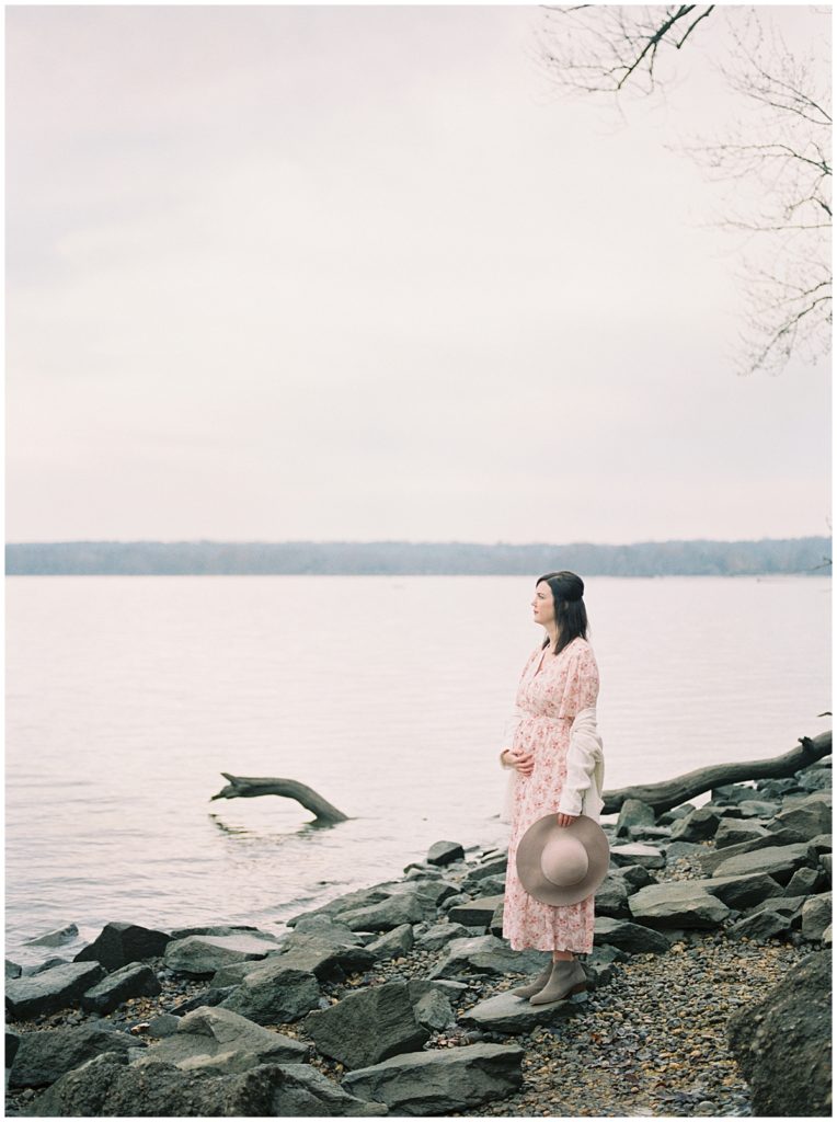 Expecting Mother Looking Out Into The Potomac River During A Dc Maternity Session.