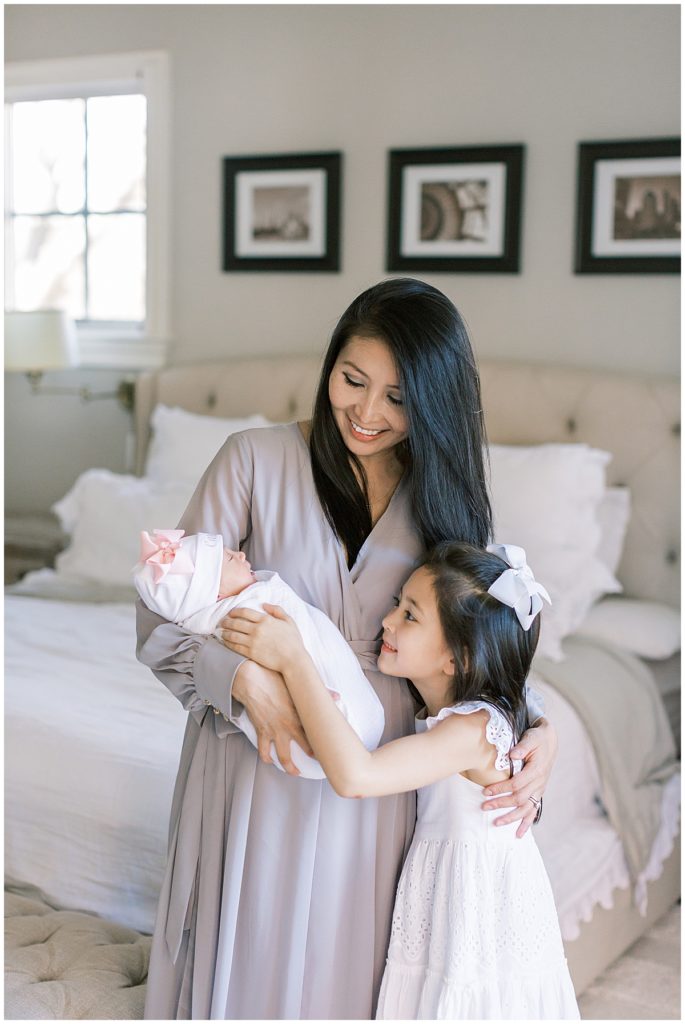 Why You Should Have A Newborn Session | Mother And Daughter Admire New Baby