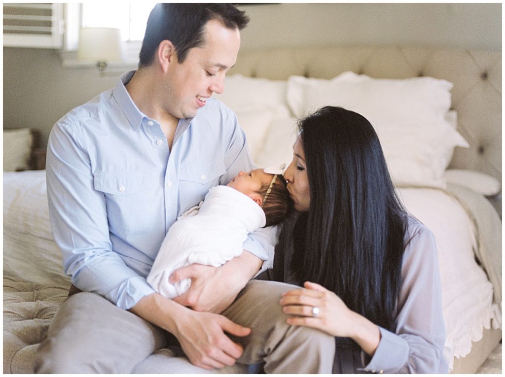 It Was A Winter Day When I Traveled To This Sweet Family’s Mclean Home. Newborn Sessions Tend To Be So Serene, But This Newborn Session Was Not Only Gorgeous, But We Played So Many Games With Carson’s Three Older Siblings. It Was Darling To See Them Welcome Their Baby Sister. Mama Wore A Stunning Gown From The Client Wardrobe, And I Know Their Family Will Cherish These Moments For Years To Come. I Am So Glad They Trusted Me To Be Their Northern Virginia Newborn Photographer - Mother Kissing Baby's Head