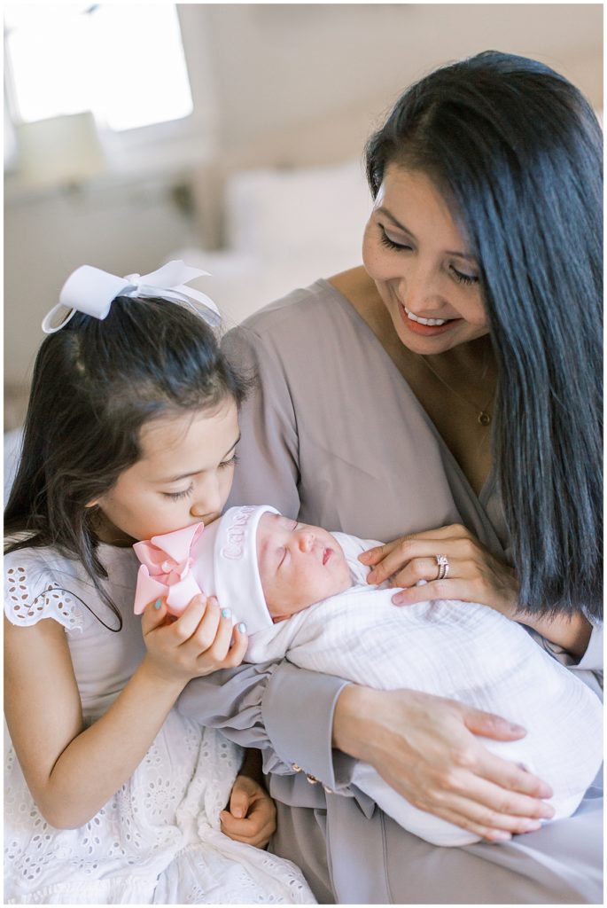 Big Sister Kisses Baby Sister's Head