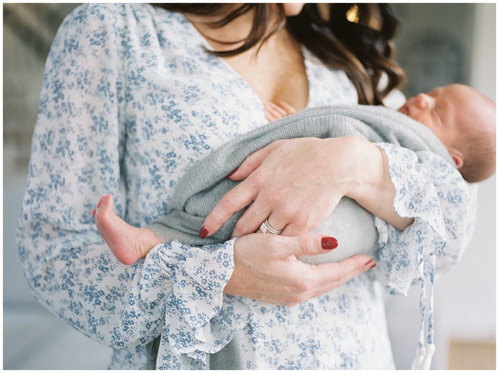 Mother Holds Infant During Arlington Newborn Session Outside Of Washington Dc.