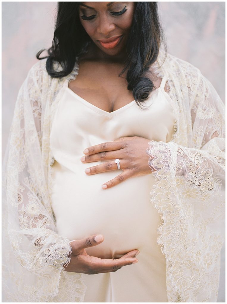 Pregnant Mother Looks Down At Her Baby Bump