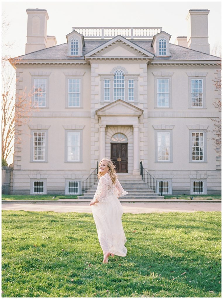 Woman Running Towards The Great Marsh Estate During Maternity Session