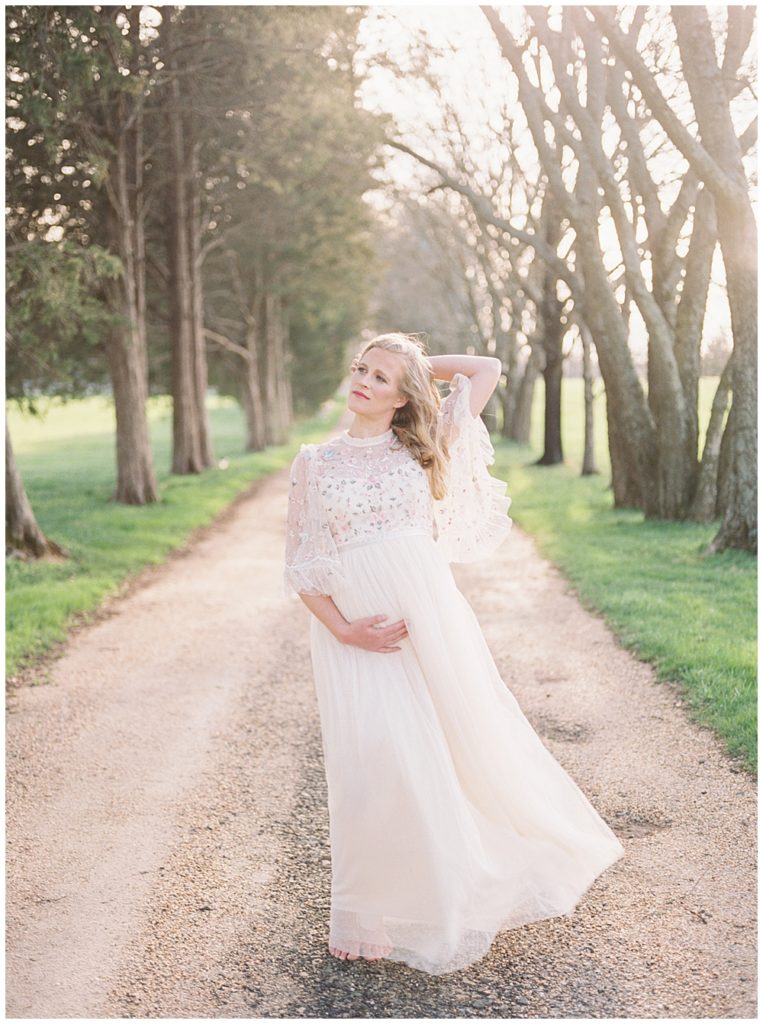 Pregnant Woman Basks In The Sun's Rays On Lane At The Great Marsh Estate During Fine Art Maternity Session