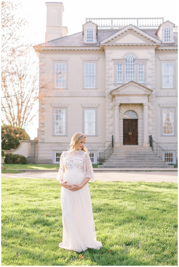 Pregnant Woman Stands In Front Of The Great Marsh Estate