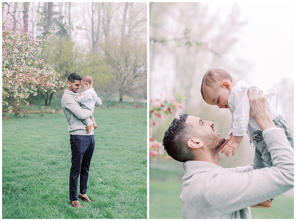 Father Holds His Son During A Family Session In A Garden.