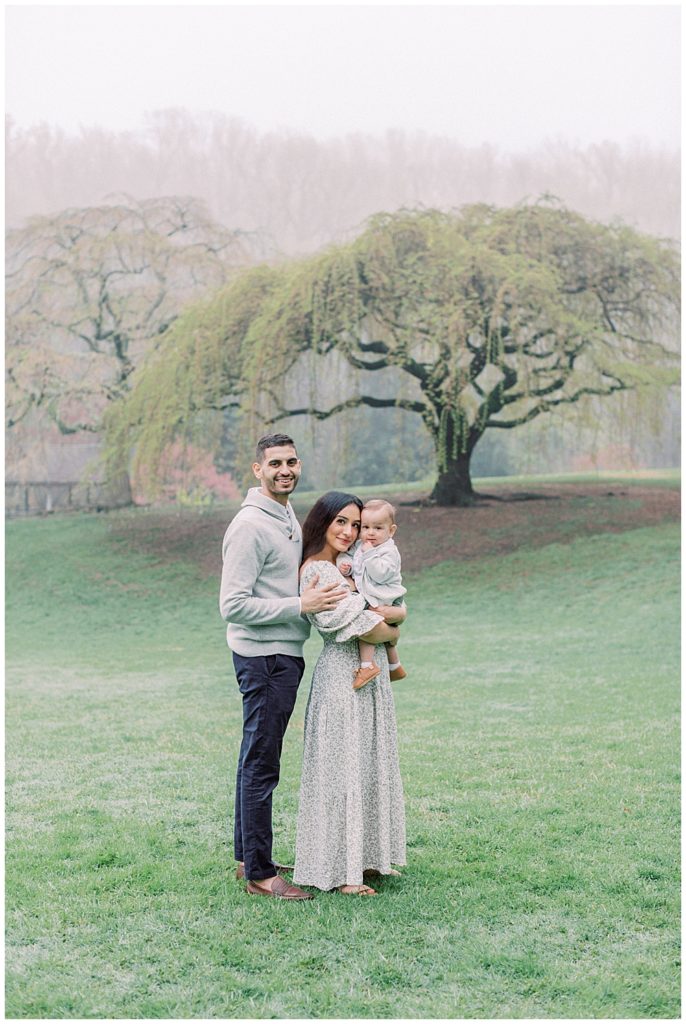 Young Family Stands In Brookside Gardens During A Maryland Family Photo Session.