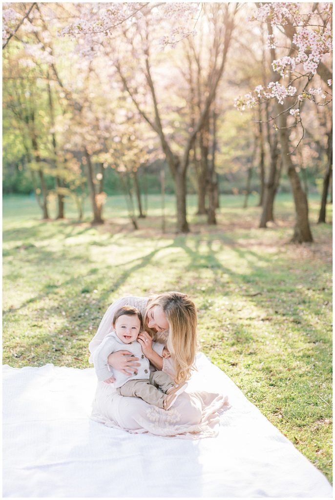 Family Photographer In Dc | Mom Cuddles With Her Baby At The National Arboretum Cherry Blossoms