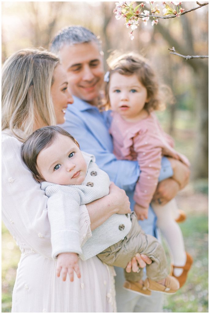 Baby Boy Looks At The Camera While His Mother Holds Him