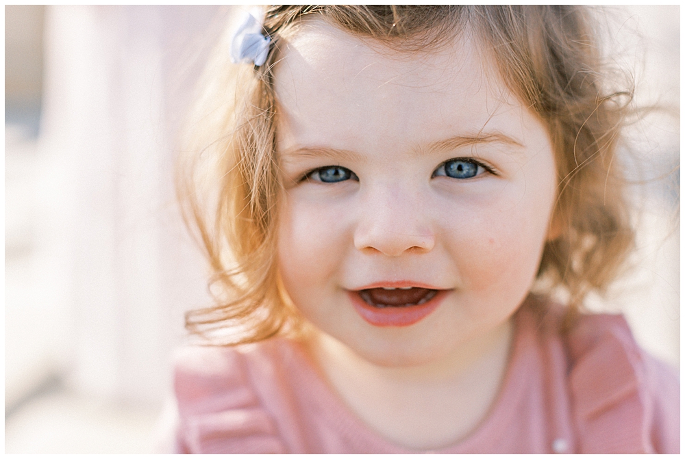 Little Girl Smiles Up Close To The Camera