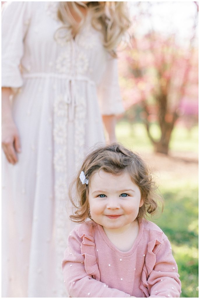 Little Girl Smiles With Her Mother During A Photo Session At The National Arboretum In Washington, D.c.