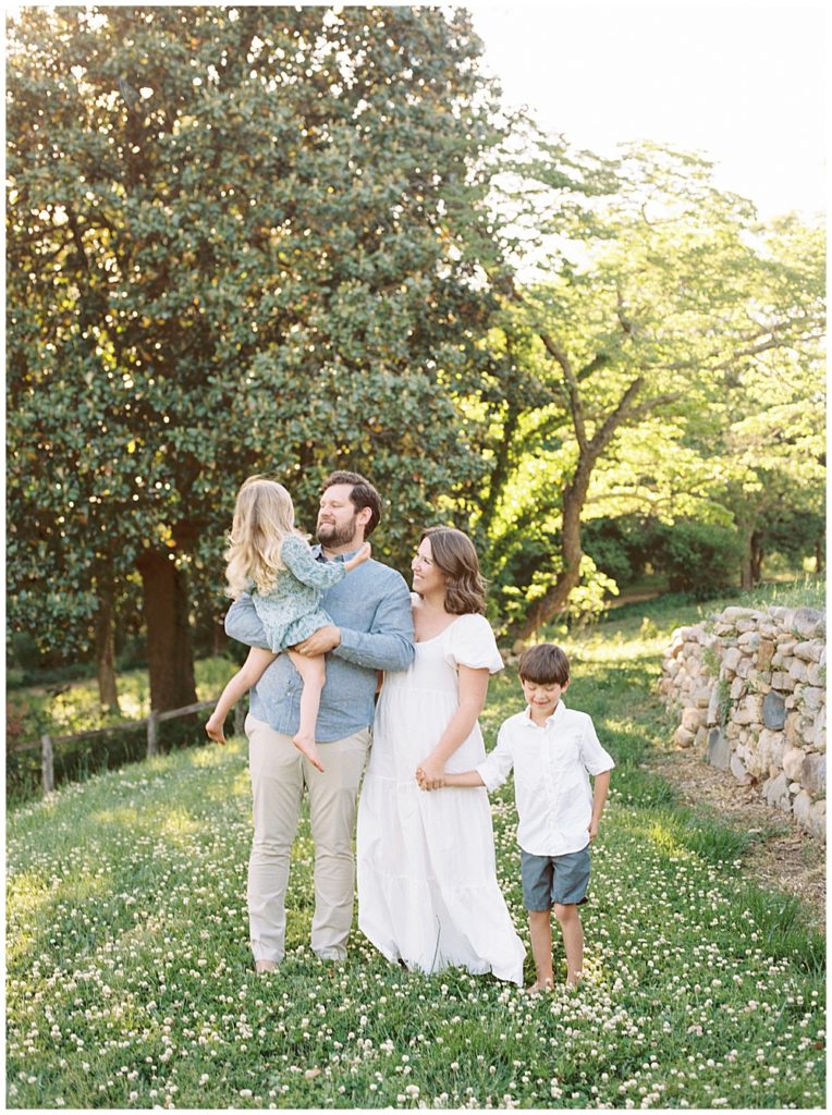 Family Stands Together In A Field During Their Photo Session