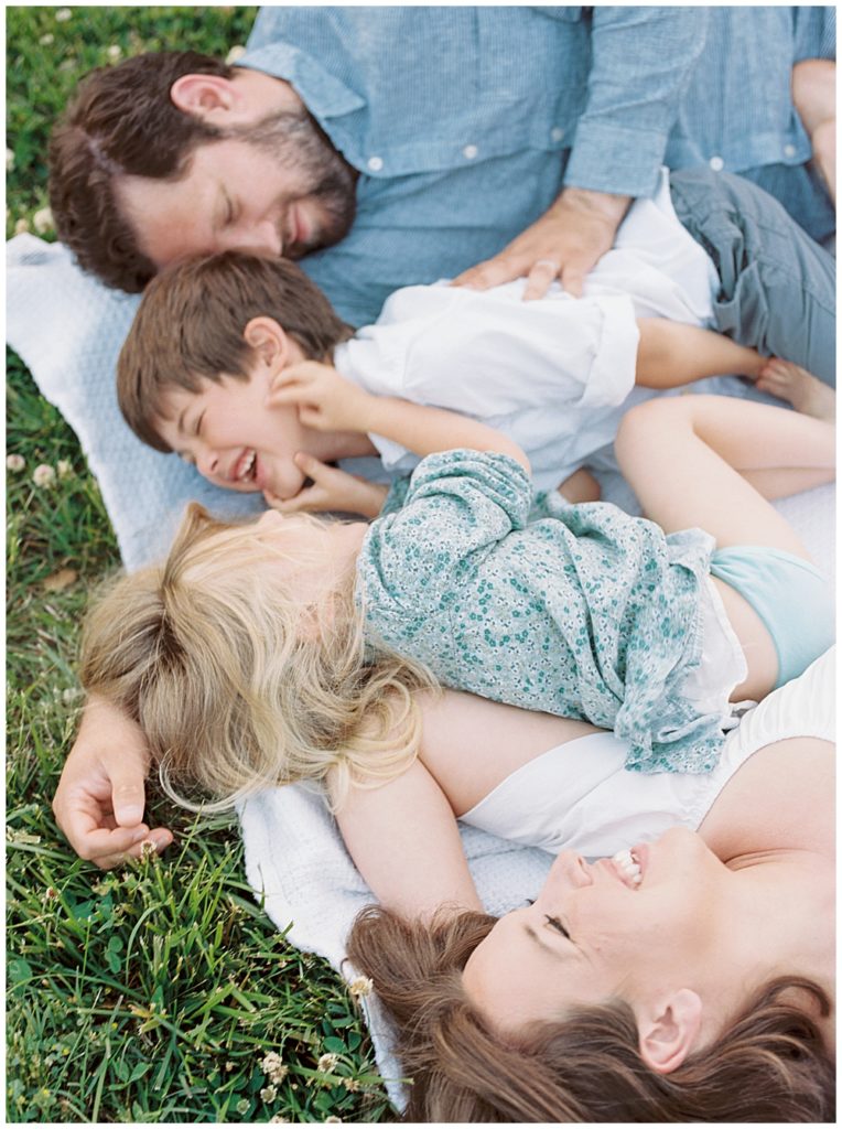 Family Lays Down And Laughs Together During Their Family Photo Session