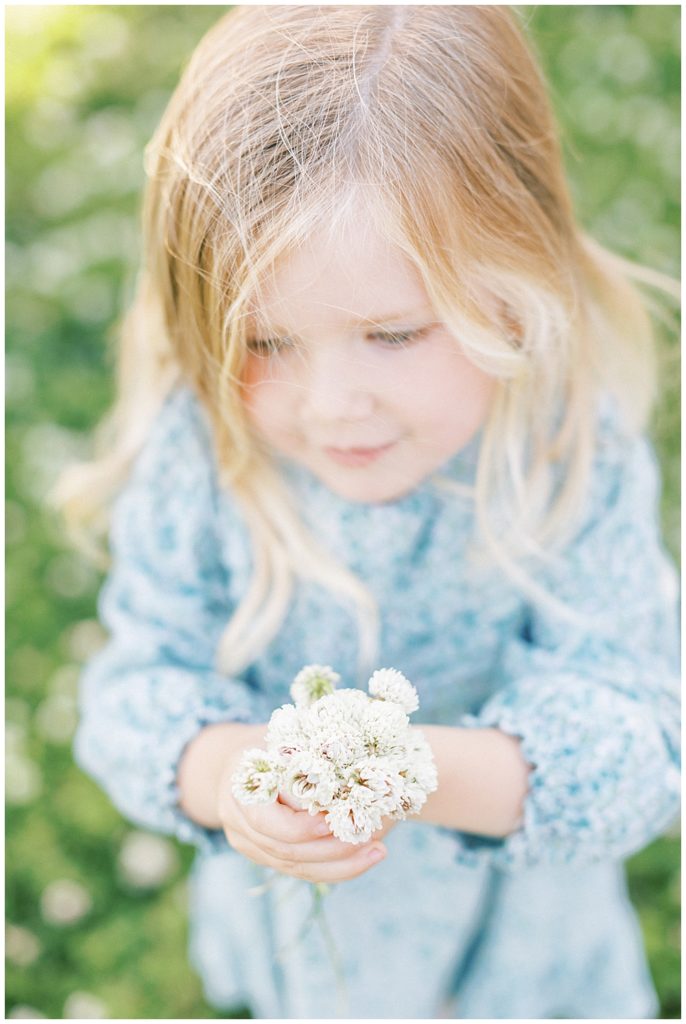 Little Girl Holds Up Flowers At Mulberry Fields In Maryland