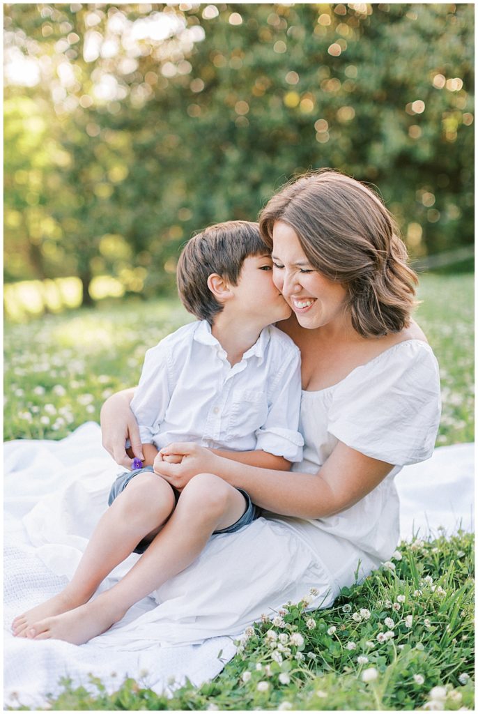 Little Boy Whispers Into His Mother's Ear