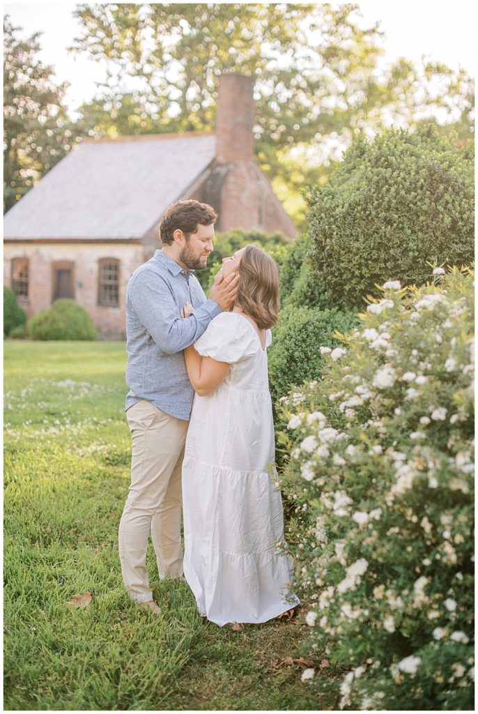 Husband And Wife Hold One Another During Their Family Photo Session