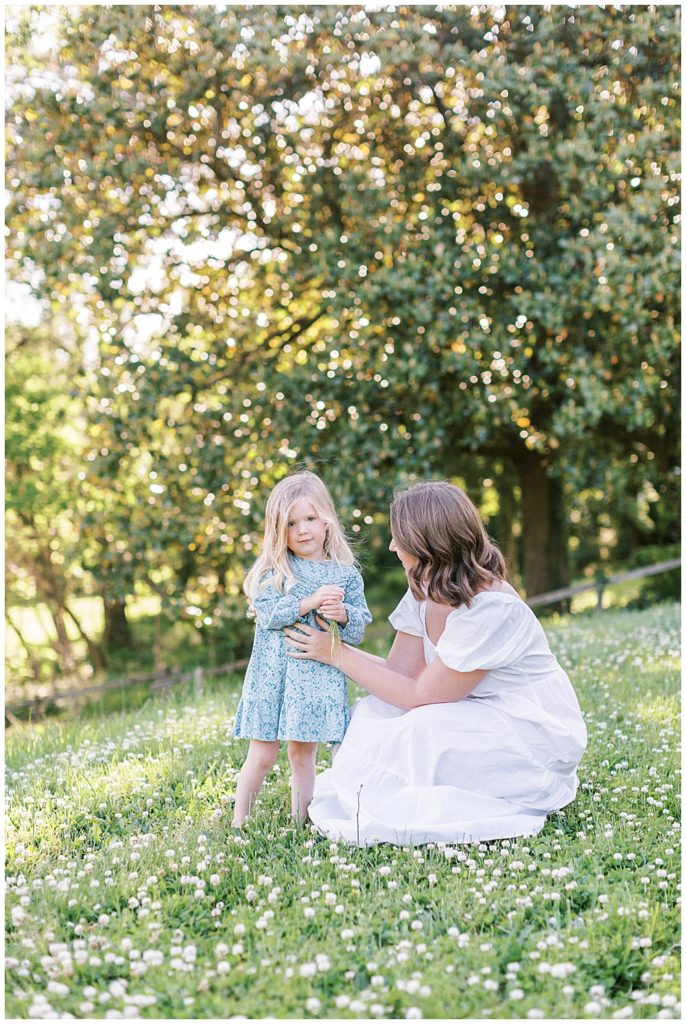 Mother Crouches Down To Talk To Her Daughter