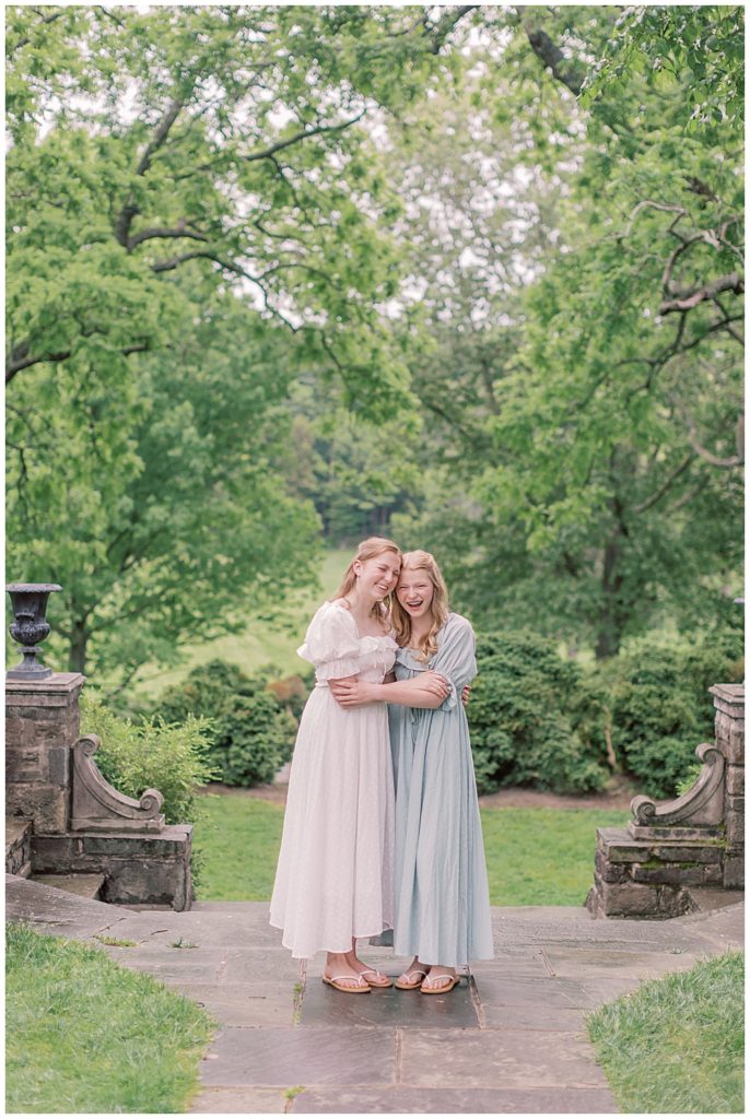 Two Teen Girls Hold Each Other During A Family Photo Session At Glenview Mansion