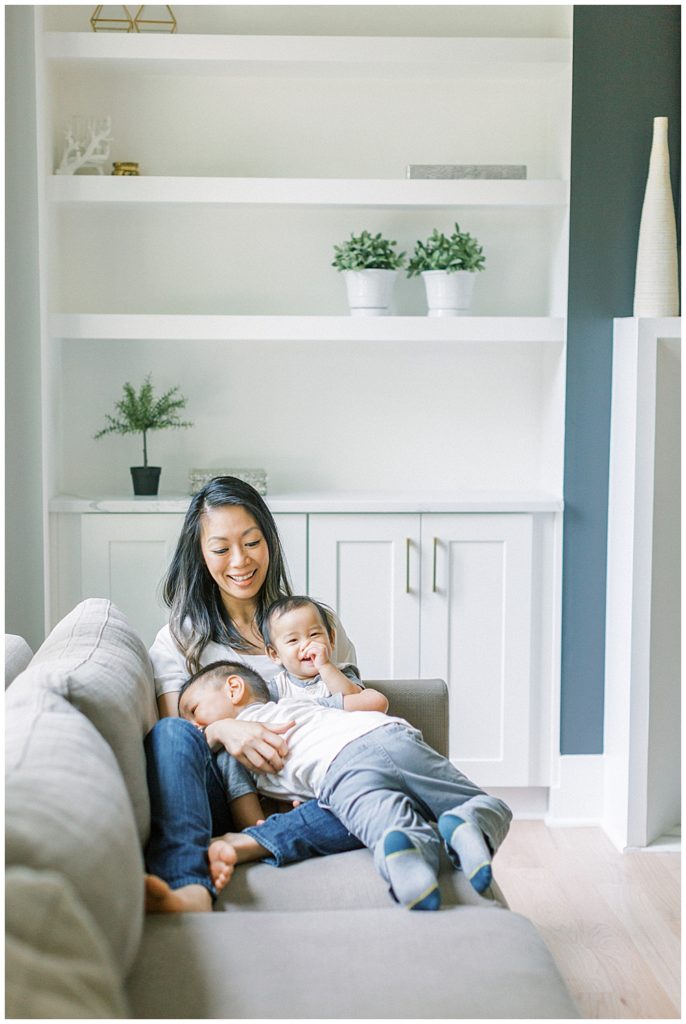 Mother Lays On A Couch With Her Two Sons During A Northern Virginia Lifestyle Family Session