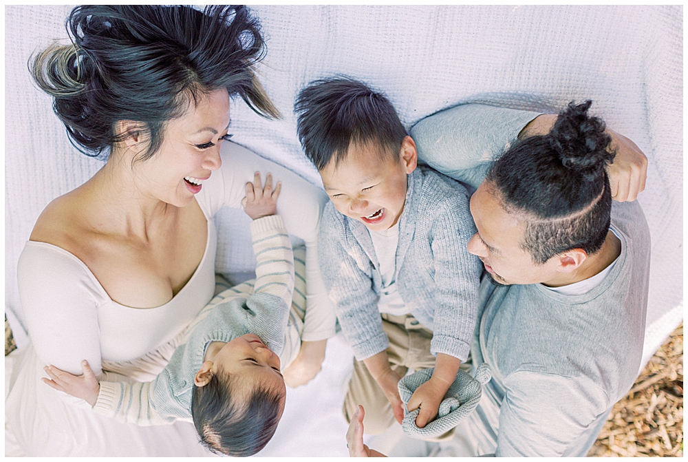 Washington, D.c. Family Photographer | Family Lays On A Blanket During Their Brookside Gardens Family Session