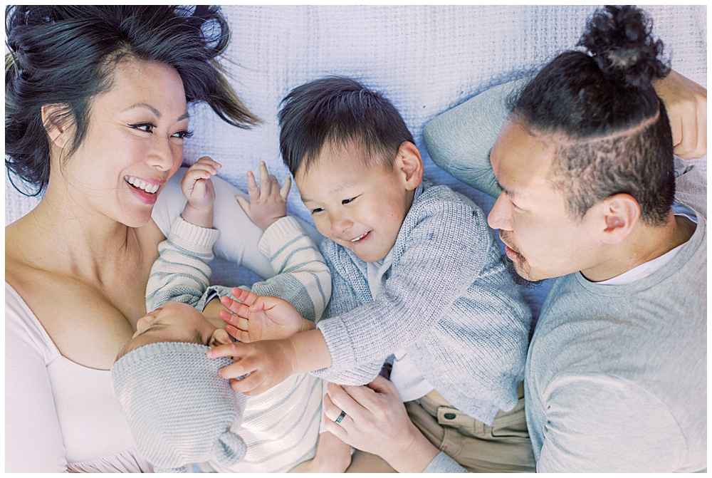 Washington, D.c. Family Photographer | Family Laughs Together While Laying Down On A Blanket