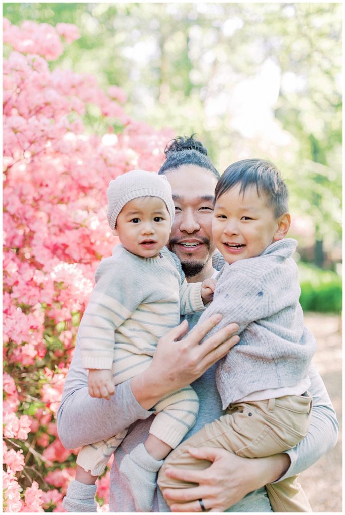 Father Holds His Sons Near The Pink Azaleas At Brookside Gardens