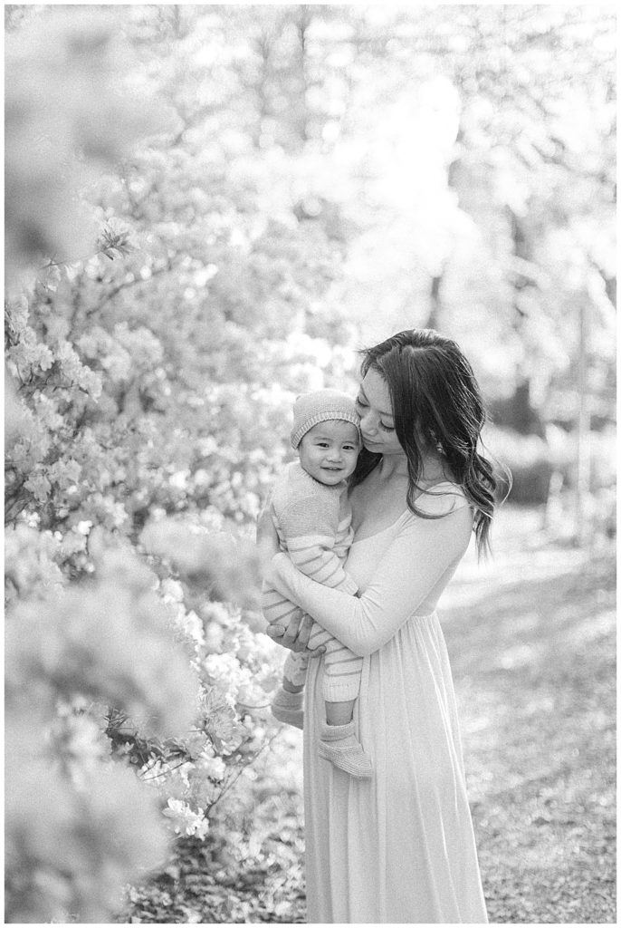 Mother Holds Her Son In A Garden