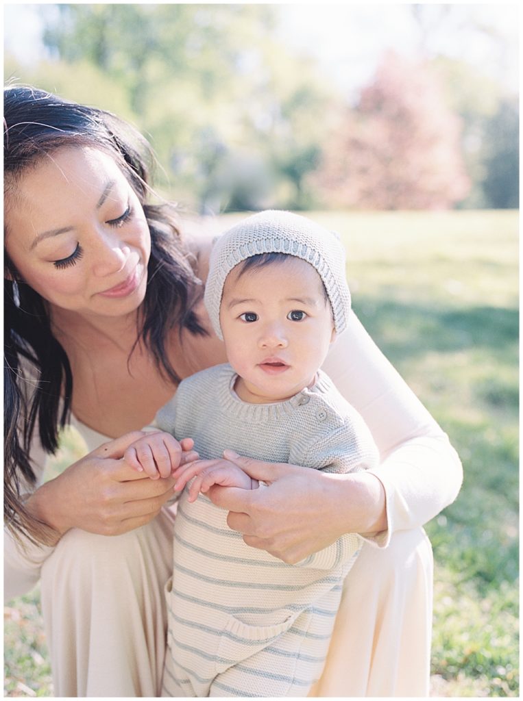 Washington D.c. Family Photographer - Mother Crouches Down With Her Infant Son At Brookside Gardens