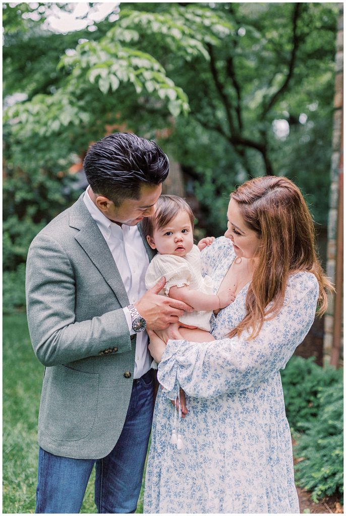 Mother And Father Hold Their One Year Old During Their Arlington Family Session