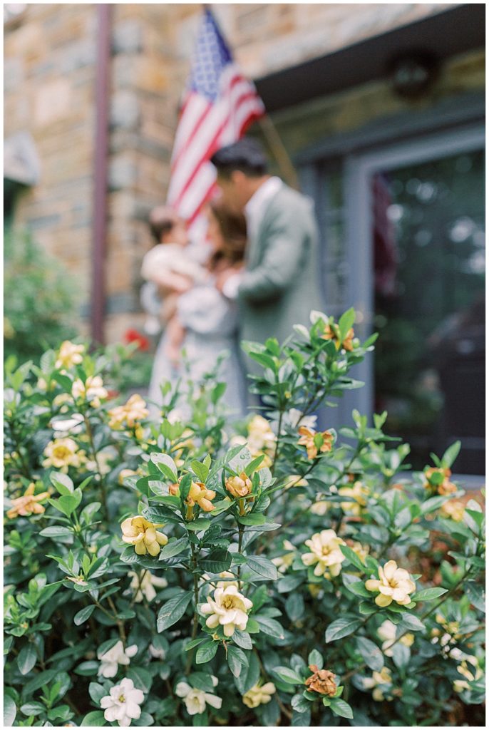 Nova Family Photographers | A Family Stands In Front Of Their Home With Their One Year Old Daughter During Their Arlington Family Session