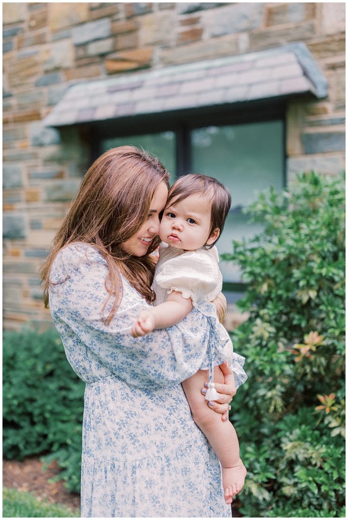 Mother Snuggles With Her Daughter In Front Of Her Arlington Home