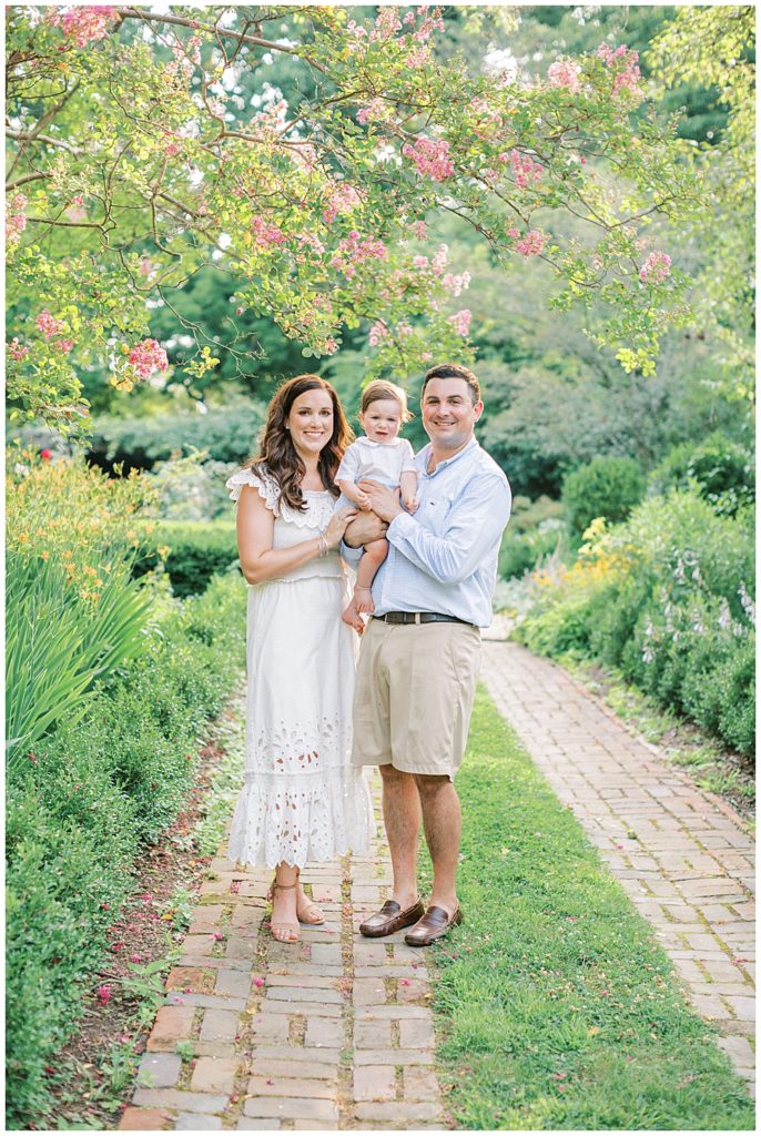 Family Stands Together And Smiles During Their Tudor Place Photo Session