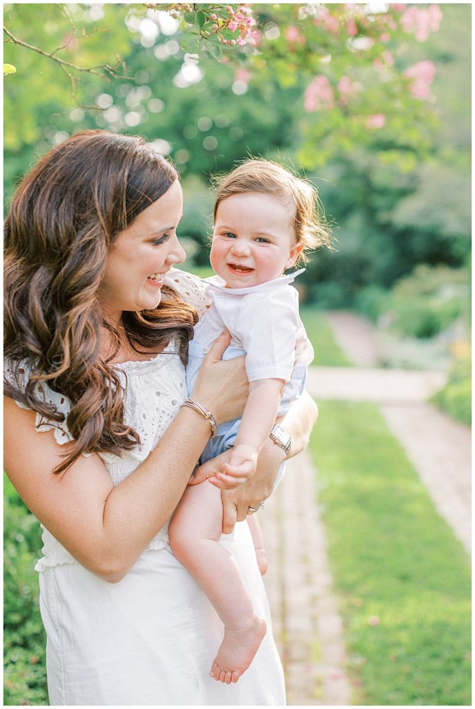 Little Boy Smiles While His Mother Plays With Him