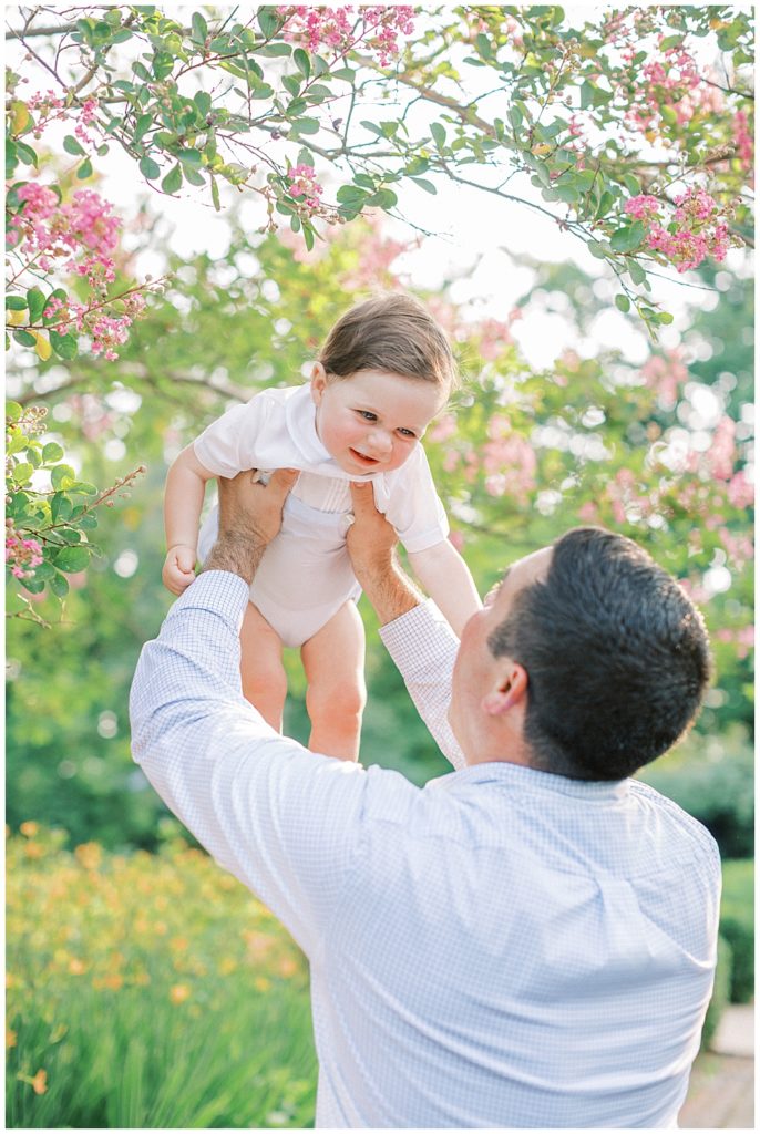 Dad Holds His Son Up In The Air At Tudor Place In Dc