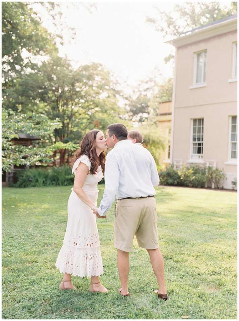 Parents Stop For A Kiss While Walking On The Grounds Of Tudor Place