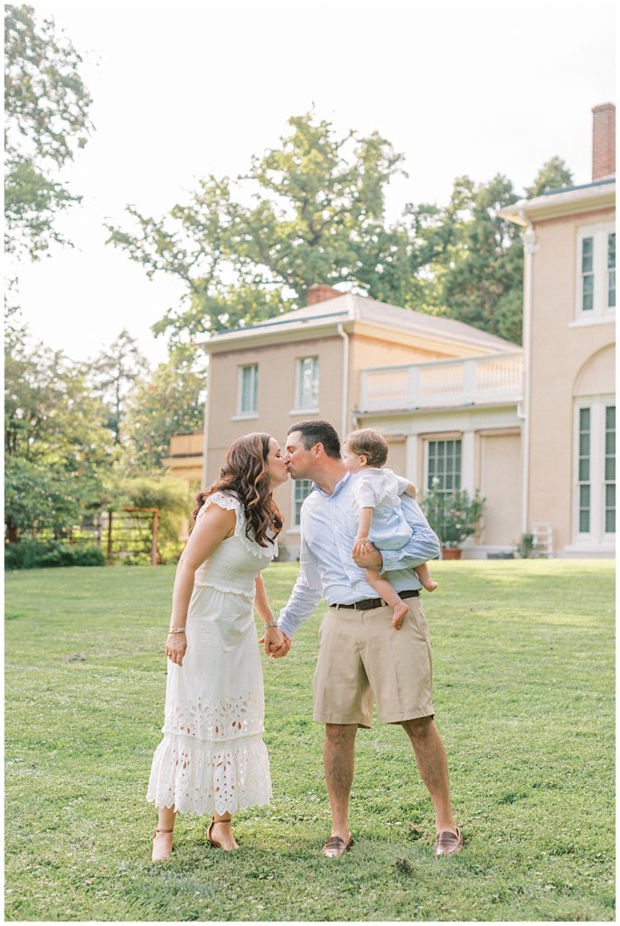 Parents Kiss While Holding One Year Old