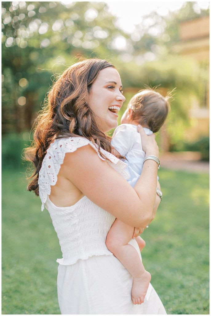 Mother Holds Her Baby And Laughs