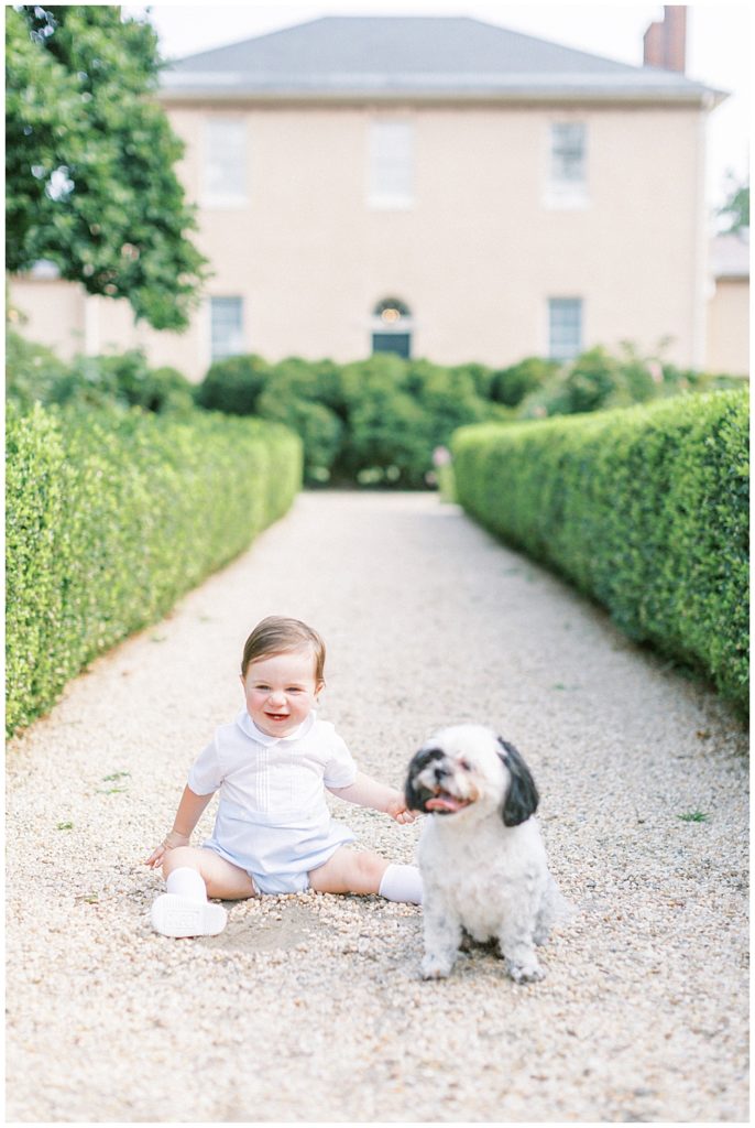 Baby Boy Sits With His Small Dog And Laughs