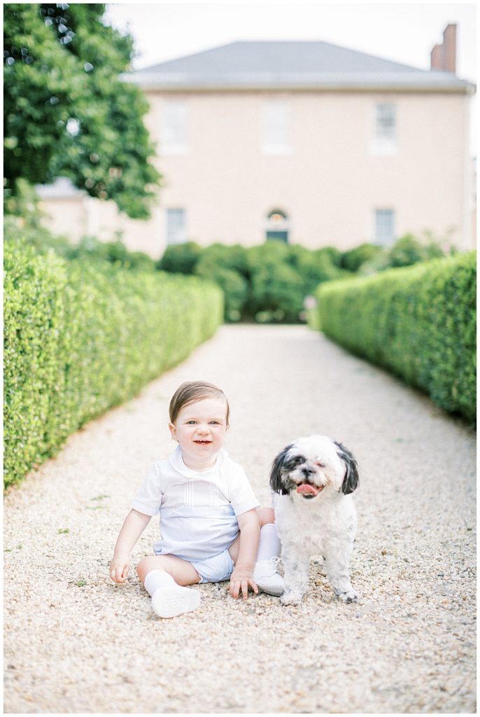 Boy And Dog Sit And Smile