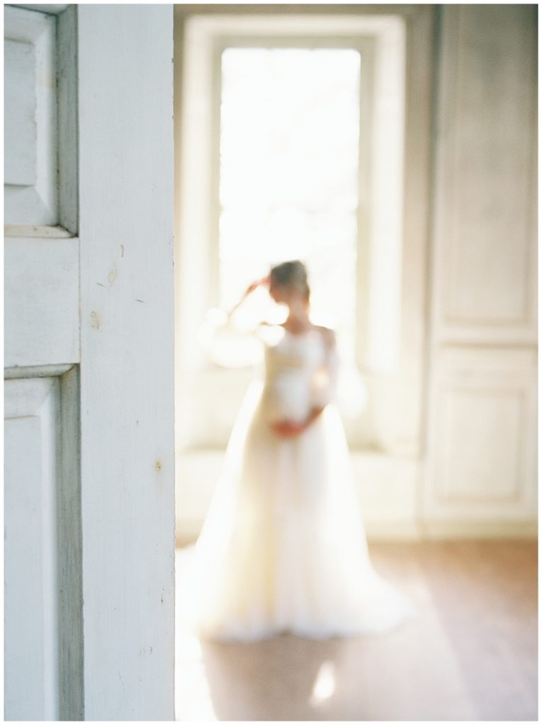 Out Of Focus Image Of Pregnant Woman Standing In Salubria With Hand On Head