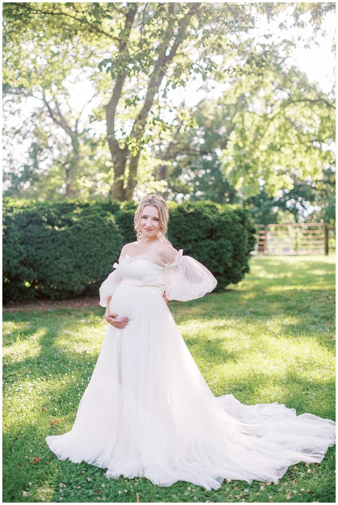 Romantic Maternity Portrait | Pregnant Woman Stands With Her Hand On Her Back And Belly During Her Dc Maternity Session