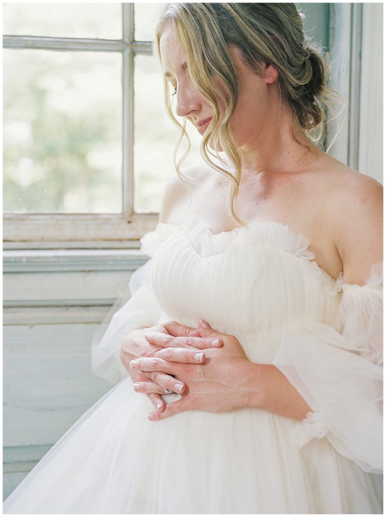 Woman Rests Both Hands On The Top Of Her Pregnant Belly During Her Dc Maternity Session