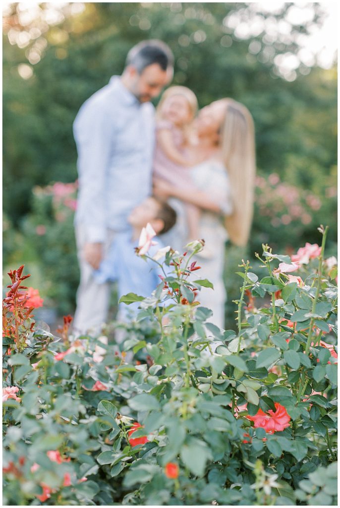 Family Cuddles Together In The Bon Air Rose Garden