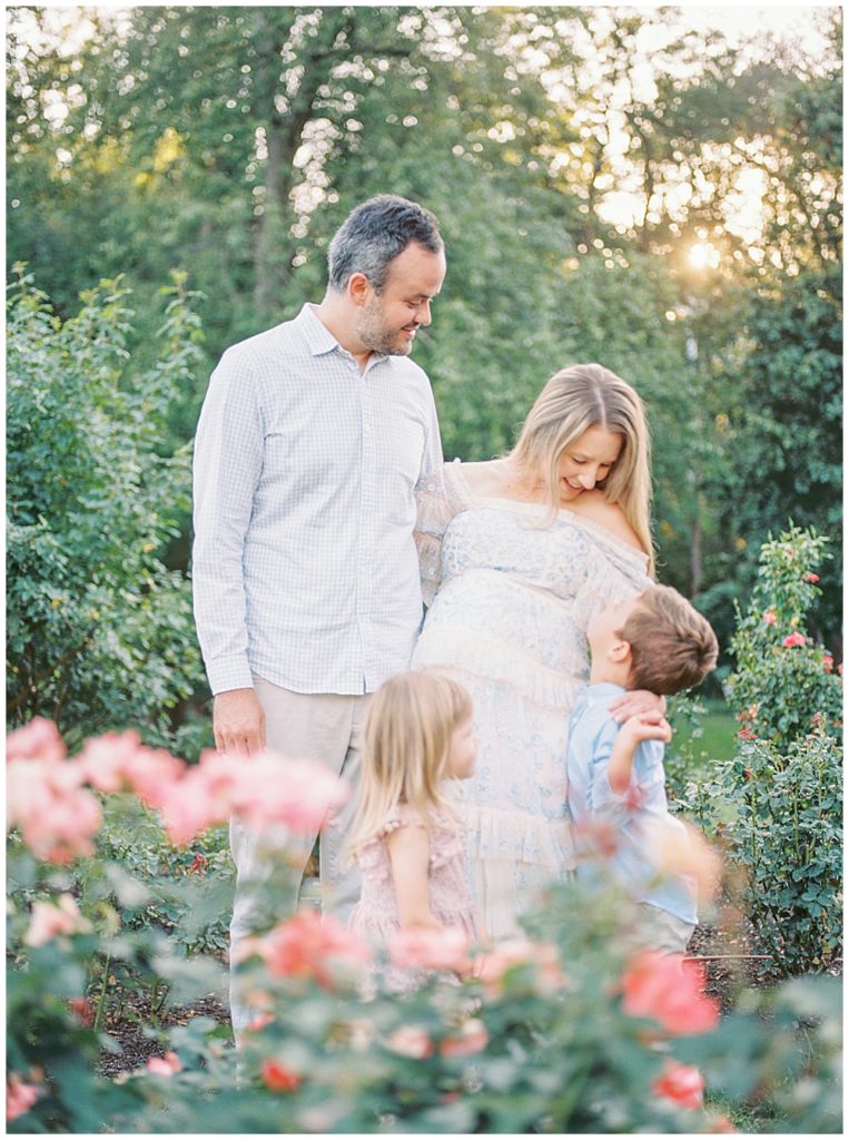 Family Stands Behind Roses In The Bon Air Rose Garden In Arlington Va