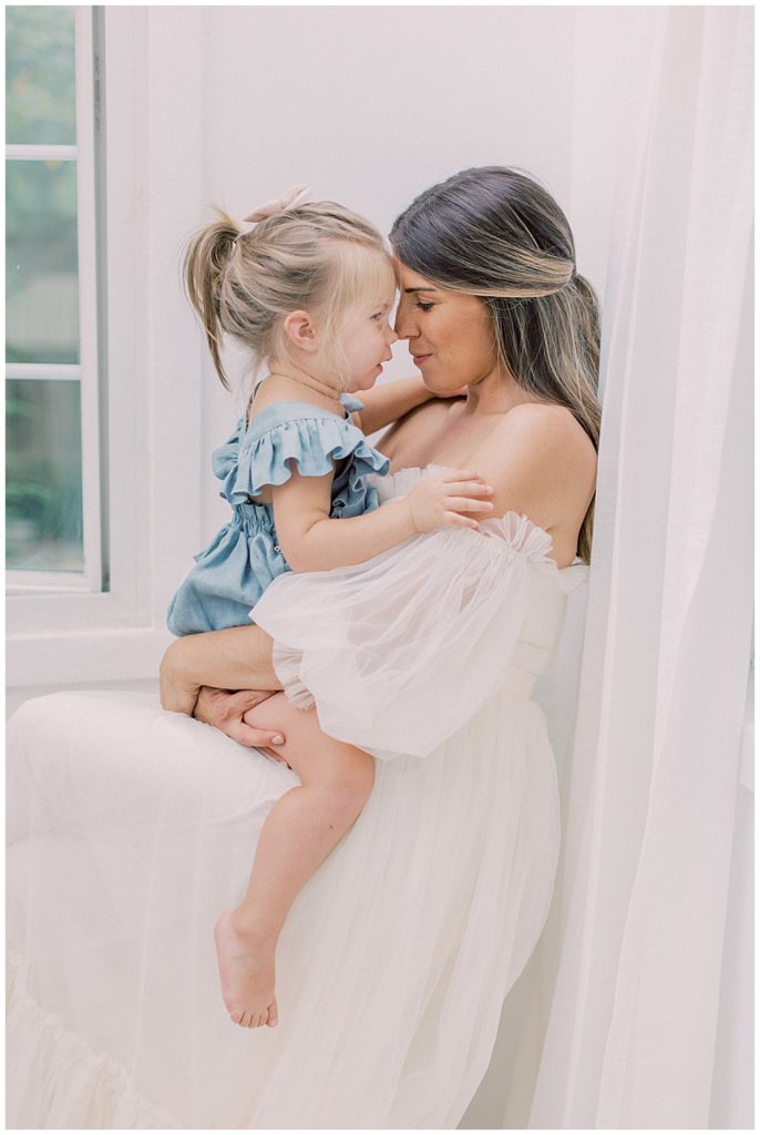 Mother And Daughter Nose Nuzzle During Their Maternity Session Outside Of Washington Dc